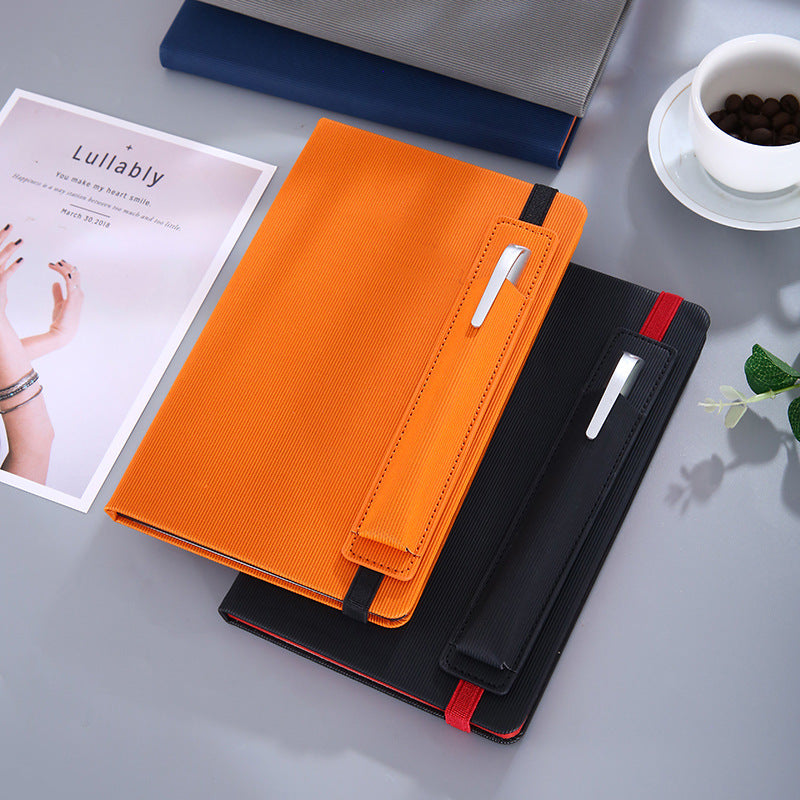 Orange and black notebooks on a desk