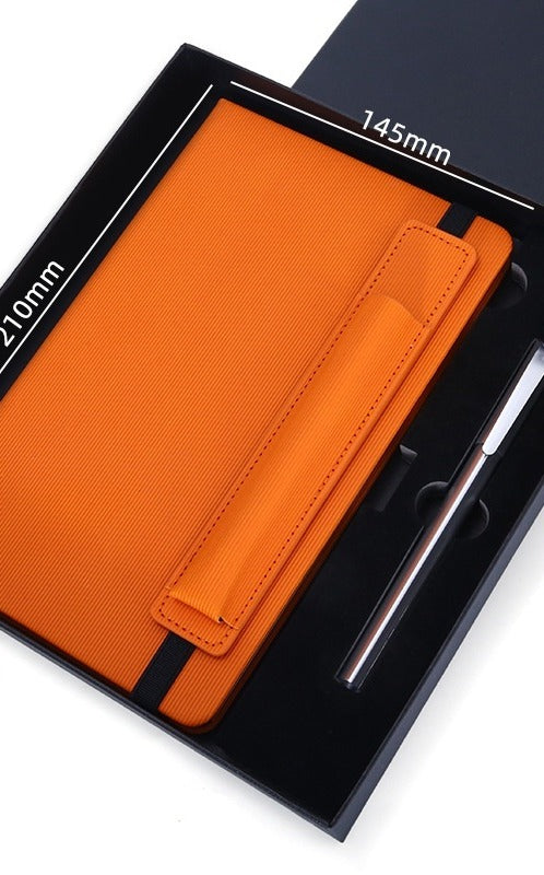 Orange vegan leather notebook and metal pen in gift box